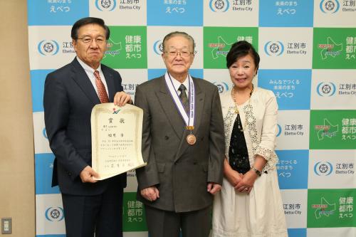 メダルをかけた福見さんと市長の写真