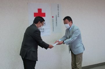 龍田代表理事が義援金を手渡している写真