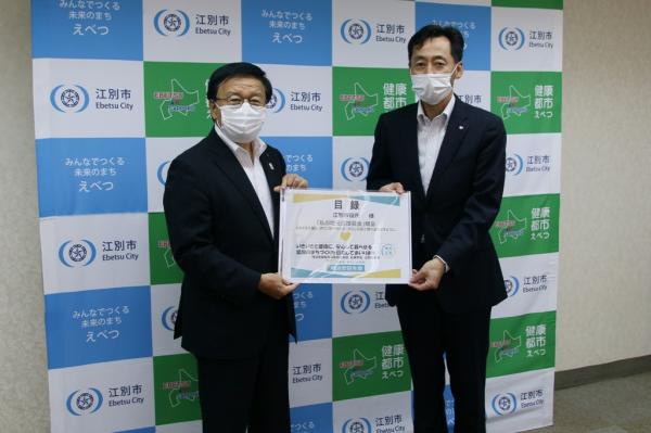 明治安田生命保険相互会社から寄付を受ける江別市長の写真