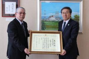 表彰状を手に受賞報告する武田氏と市長の写真
